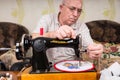 Senior Man Doing Needlepoint on Sewing Machine Royalty Free Stock Photo