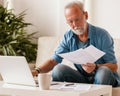 Senior  man doing paperwork at home Royalty Free Stock Photo