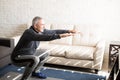 Mature man doing squats workout at home Royalty Free Stock Photo