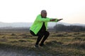 A senior man doing squats on a field Royalty Free Stock Photo