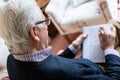 Senior Man Doing Sudoku Puzzle At Home