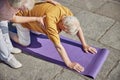 Senior man doing yoga on the mat