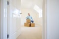 Senior Man Downsizing In Retirement Sitting On Boxes In New Home On Moving Day Royalty Free Stock Photo