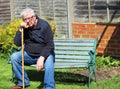 Senior man dozing on park bench.