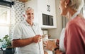 Senior man, drinking coffee and conversation with woman in kitchen at home in New Zealand. Happy, elderly and smile Royalty Free Stock Photo