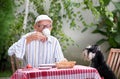 Senior man drinking coffee in garden Royalty Free Stock Photo