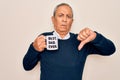 Senior man drinking cup of coffee with best dad ever message over white background with angry face, negative sign showing dislike Royalty Free Stock Photo