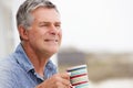 Senior man drinking tea outdoors Royalty Free Stock Photo