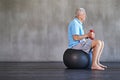 Senior man, dumbbells and workout with ball for fitness, wellness and physiotherapy at gym on mockup space. Elderly Royalty Free Stock Photo