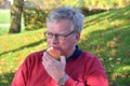 Senior man eating apple Royalty Free Stock Photo