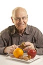 Senior man eating fresh fruit