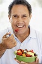 Senior Man Eating Fresh Fruit Salad