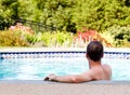 Senior man by edge of swimming pool Royalty Free Stock Photo