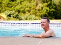 Senior man by edge of swimming pool Royalty Free Stock Photo
