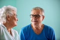 Senior man and elder woman sitting on the bed in a nursing home Royalty Free Stock Photo