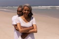 Senior man embracing senior woman on beach Royalty Free Stock Photo