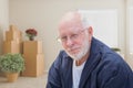 Senior Man in Empty Room with Packed Moving Boxes Royalty Free Stock Photo