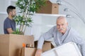 senior man in empty room with packed moving boxes Royalty Free Stock Photo