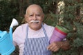 Senior man enjoying gardening outdoors Royalty Free Stock Photo