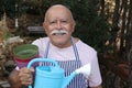 Senior man enjoying gardening outdoors Royalty Free Stock Photo