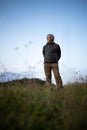 Senior man enjoying the outdoors walking throught lovely nature