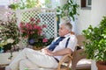 Senior man enjoying summer in garden Royalty Free Stock Photo
