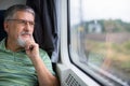 Senior man enjoying a train travel Royalty Free Stock Photo