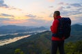 Senior man enjoys the view of cliff after hiked the hill to watch the sunrise over Mekong river in morning Royalty Free Stock Photo