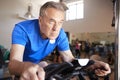 Senior Man Exercising On Cycling Machine In Gym Royalty Free Stock Photo