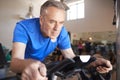 Senior Man Exercising On Cycling Machine In Gym Royalty Free Stock Photo