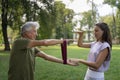 The senior man exercising in the park, using resistance band. Royalty Free Stock Photo