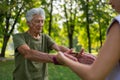 The senior man exercising in the park, using resistance band. Royalty Free Stock Photo