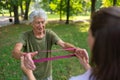 The senior man exercising in the park, using resistance band. Royalty Free Stock Photo