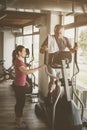 Senior man exercising on stationary bikes in fitness class. Royalty Free Stock Photo