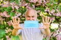 Senior man face mask. Respiratory mask. Pollen allergen. Man and flowers. Allergic reaction. Limit risk infection Royalty Free Stock Photo