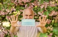 Senior man face mask. Respiratory mask. Pollen allergen. Man and flowers. Allergic reaction. Limit risk infection Royalty Free Stock Photo