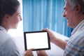 Senior man and female doctor using digital tablet Royalty Free Stock Photo