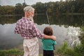 Senior man fishing with his grandson Royalty Free Stock Photo