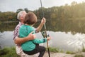 Senior man fishing with his grandson Royalty Free Stock Photo