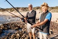 Senior man fishing with his grandson Royalty Free Stock Photo