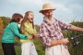 Senior man fishing on lake with his grandchildren Royalty Free Stock Photo