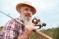 Senior man fishing on the river