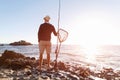 Senior man fishing at sea side Royalty Free Stock Photo