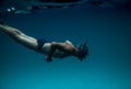 Senior Man Floating Underwater On The Blue Ocean -health And Activity Concept