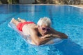 Senior man floating on water Royalty Free Stock Photo