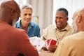 Senior man, friends and laughing for card games on wooden table in fun activity, social bonding or gathering. Group of Royalty Free Stock Photo