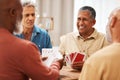 Senior man, friends and playing card games on wooden table in fun activity, social bonding or gathering. Group of Royalty Free Stock Photo