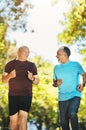 Senior man, friends and running in nature for healthy exercise or outdoor training together at park. Happy mature people Royalty Free Stock Photo