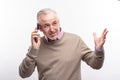 Senior man gesticulating while talking on the phone Royalty Free Stock Photo