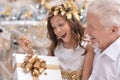 Senior man giving Christmas presents to his granddaughter Royalty Free Stock Photo